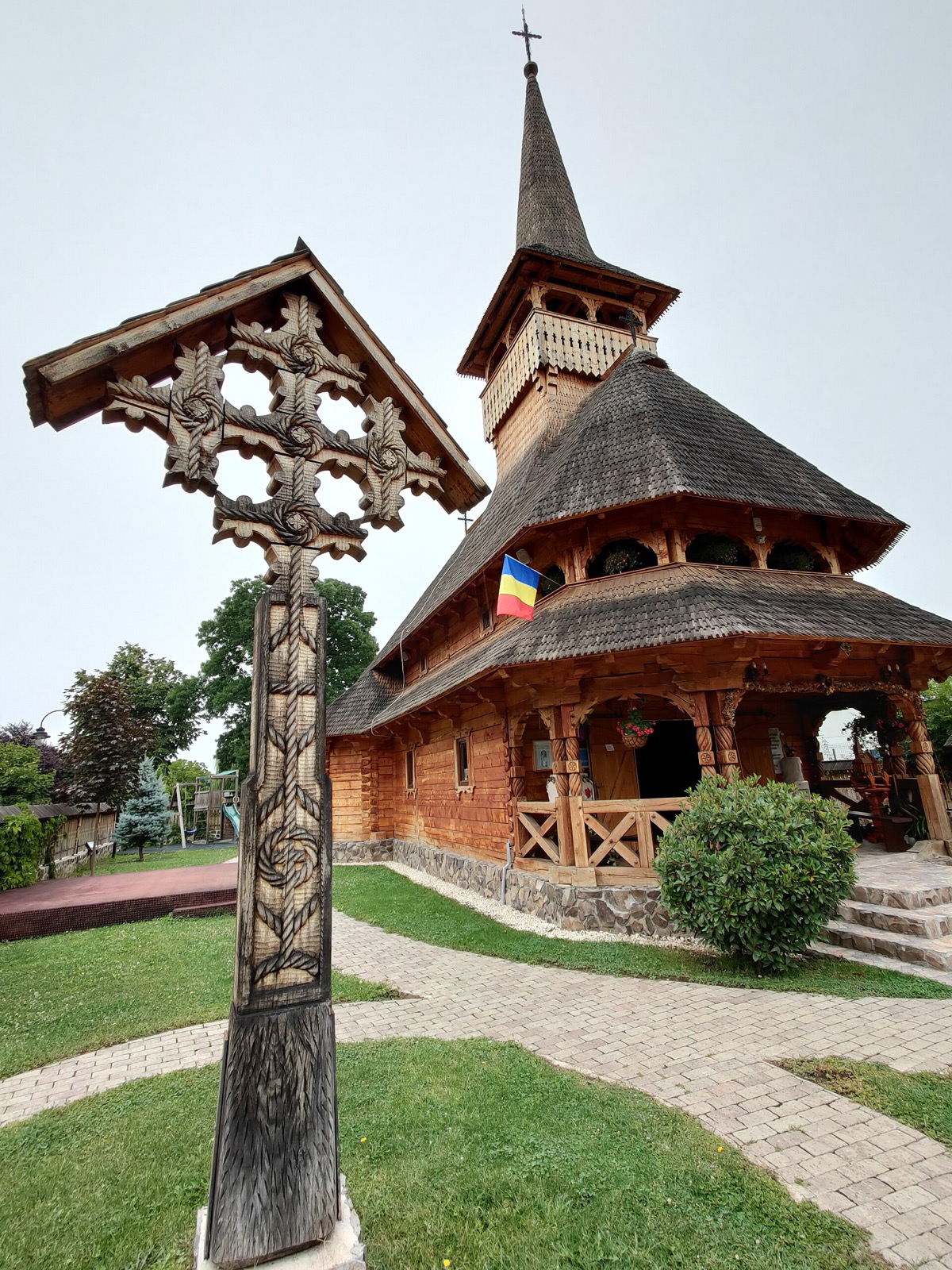 Crucea sculptată și biserica